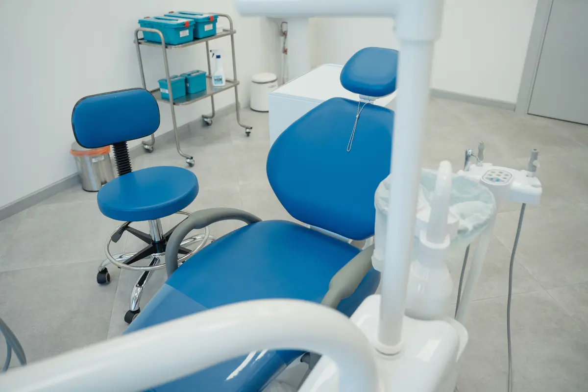 A clean general dentistry treatment room with two chairs and instrument trays