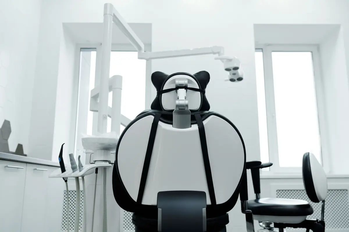 A modern dental operatory with the chair, light and equipment ready for the next patient
